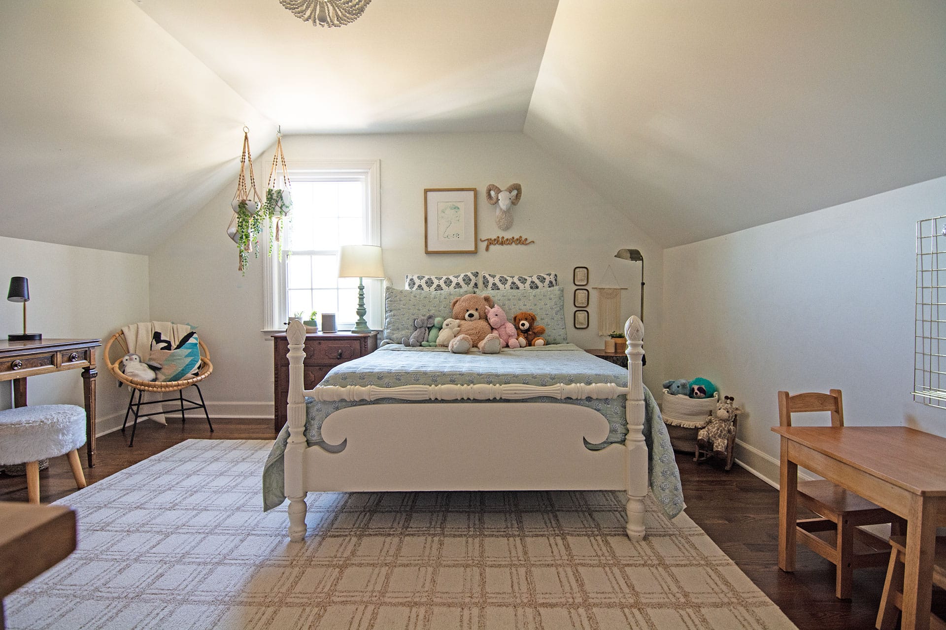 Charming girl's bedroom with a vintage-style bed, soft blue bedding, and cozy decor accents.